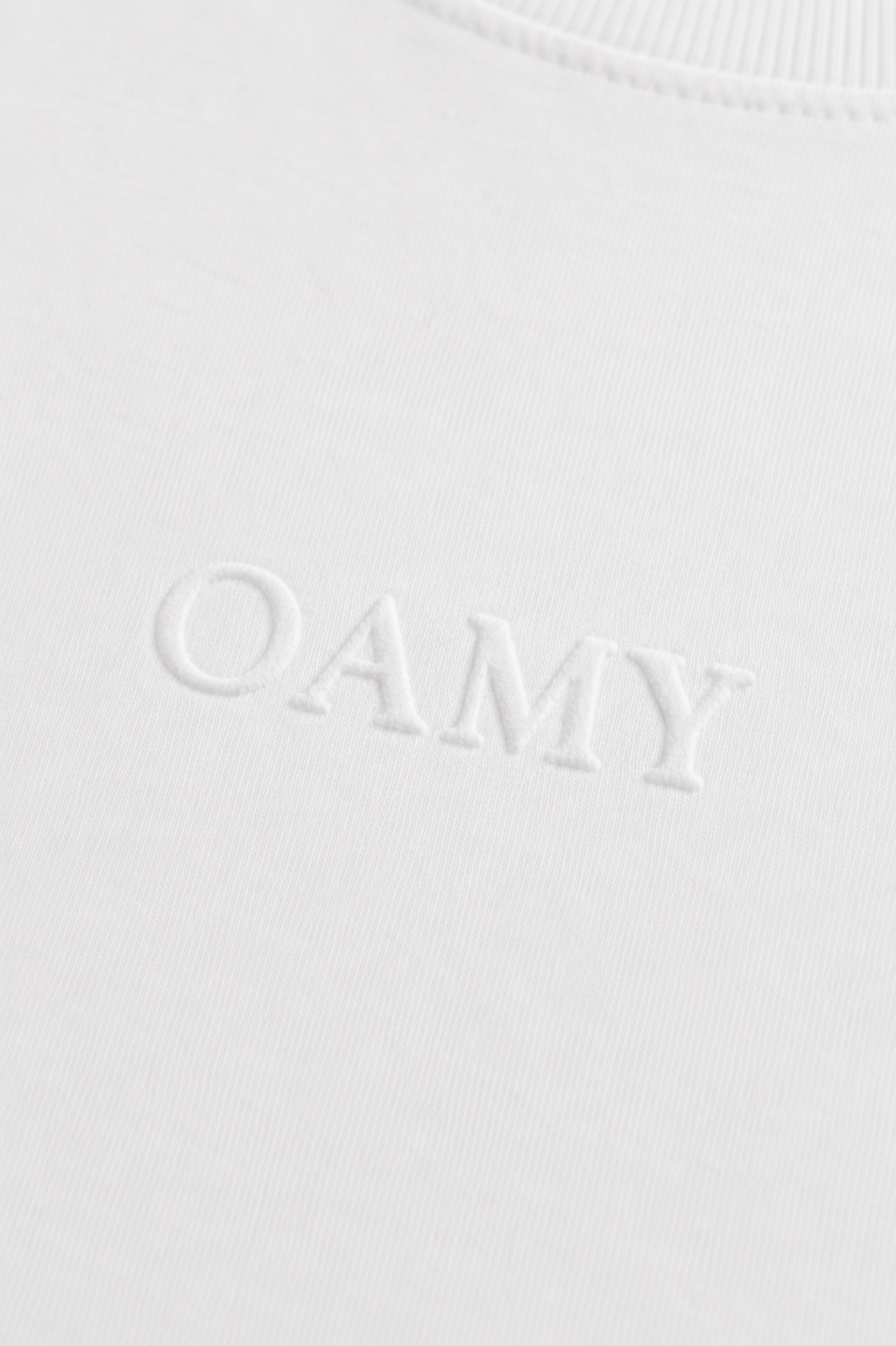 Embossed OAMY logo detail on the Elevated T-Shirt in white
