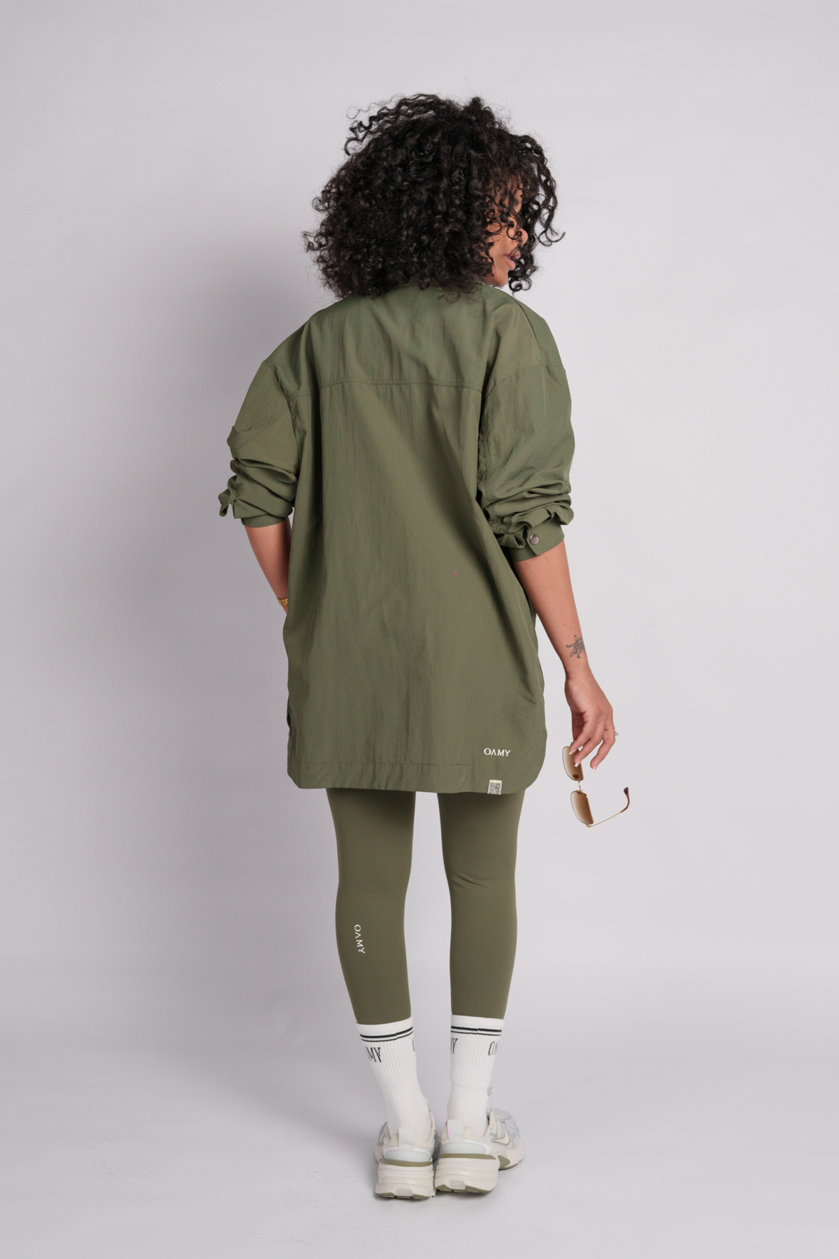 Woman wearing an olive shacket with an olive leggings.