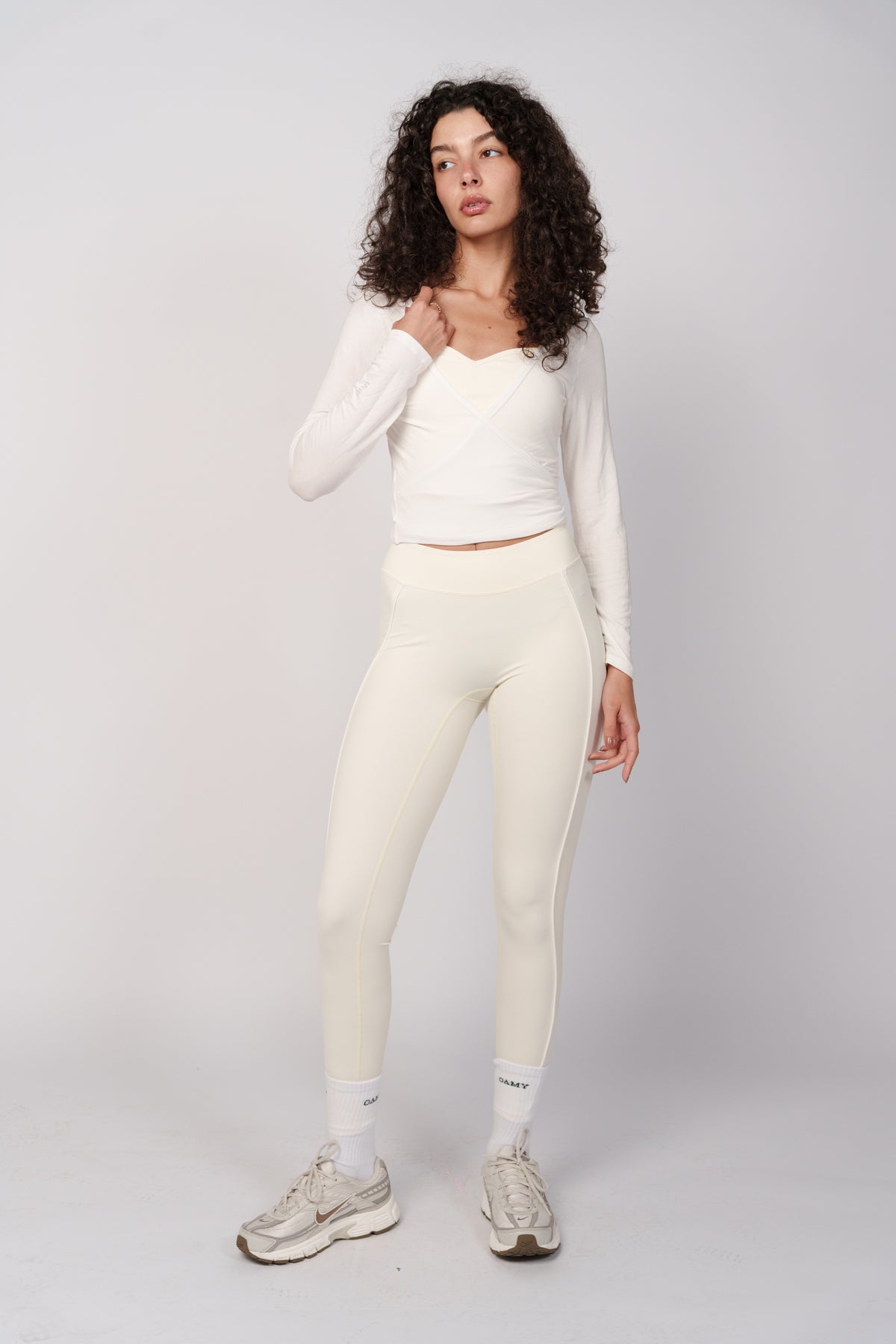 OAMY Ballet Wrap Top in White, styled with cream leggings