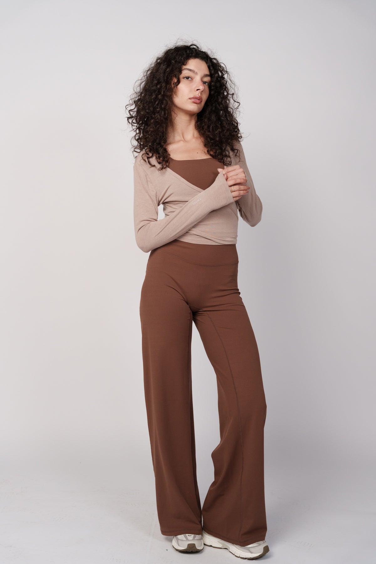 OAMY Ballet Wrap Top in Mocha, styled with brown pants