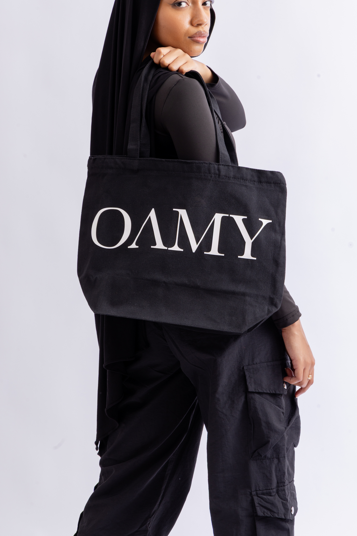 Model holding the OAMY Tote Bag in Black