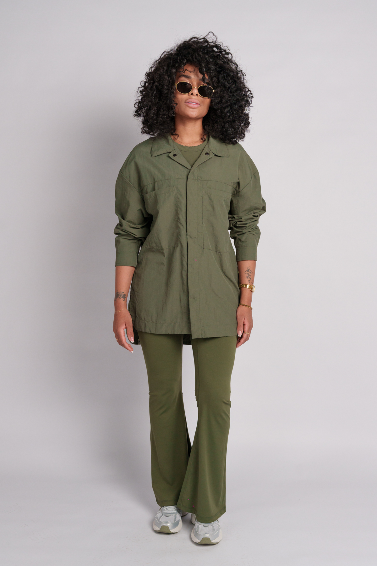 Woman wearing an olive green shirt with an olive flare