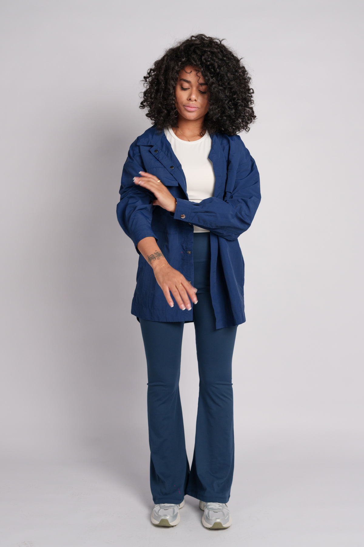Woman wearing a navy shirt with flares.