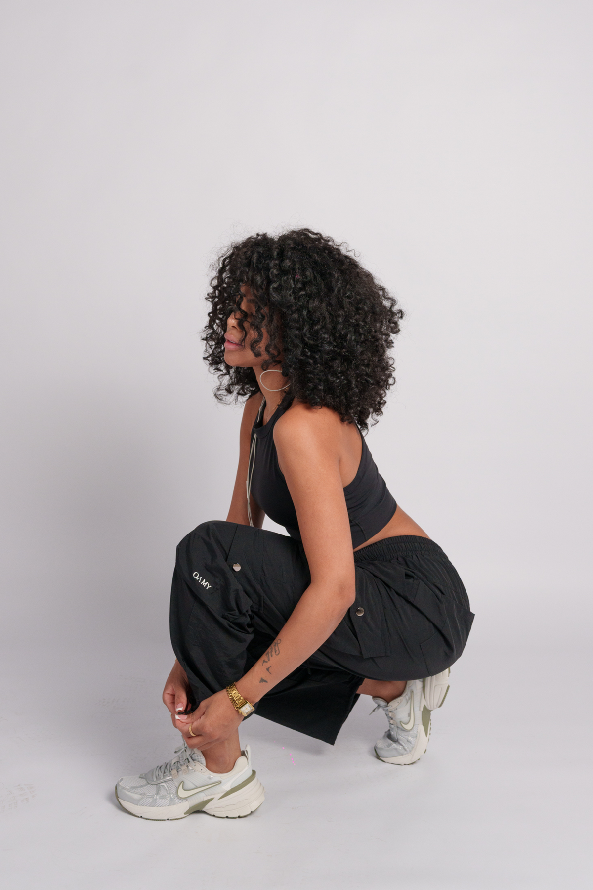 OAMY Adjustable Cargo Pant in Black, worn with the Soft-Skin Padded Crop