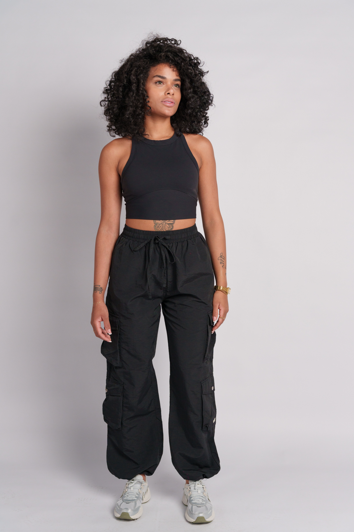 OAMY Adjustable Cargo Pant in Black, worn with the Soft-Skin Padded Crop