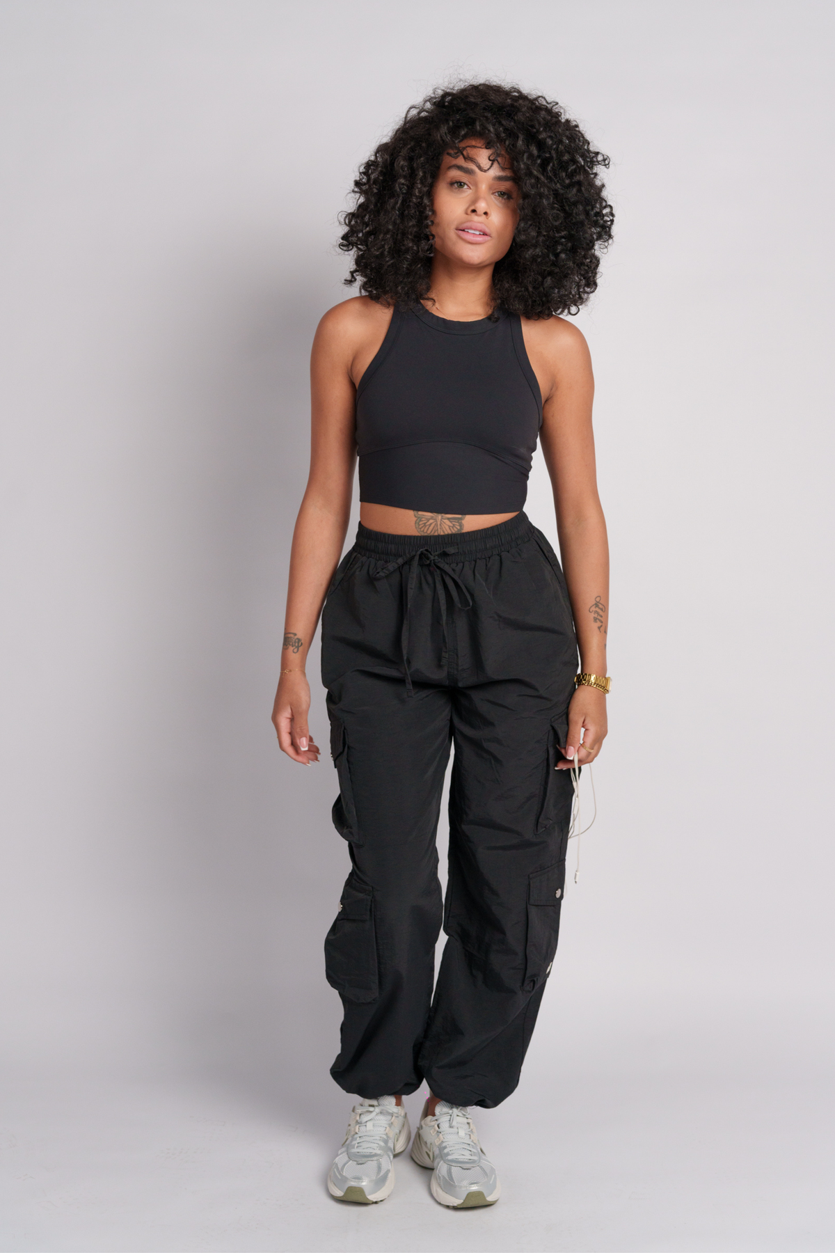 OAMY Adjustable Cargo Pant in Black, worn with the Soft-Skin Padded Crop