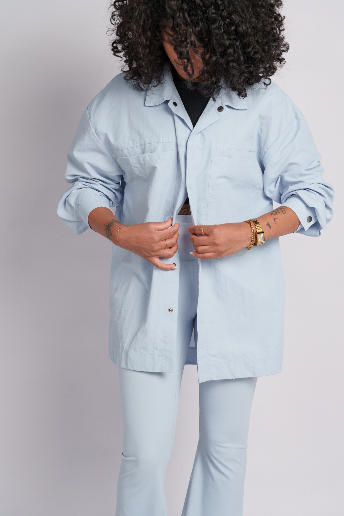 Person wearing a baby blue shirt and flares.