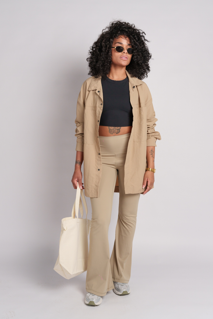 Model wearing a beige shacket and flares