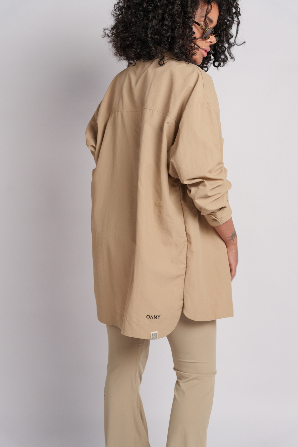 Model wearing a beige shacket and flares