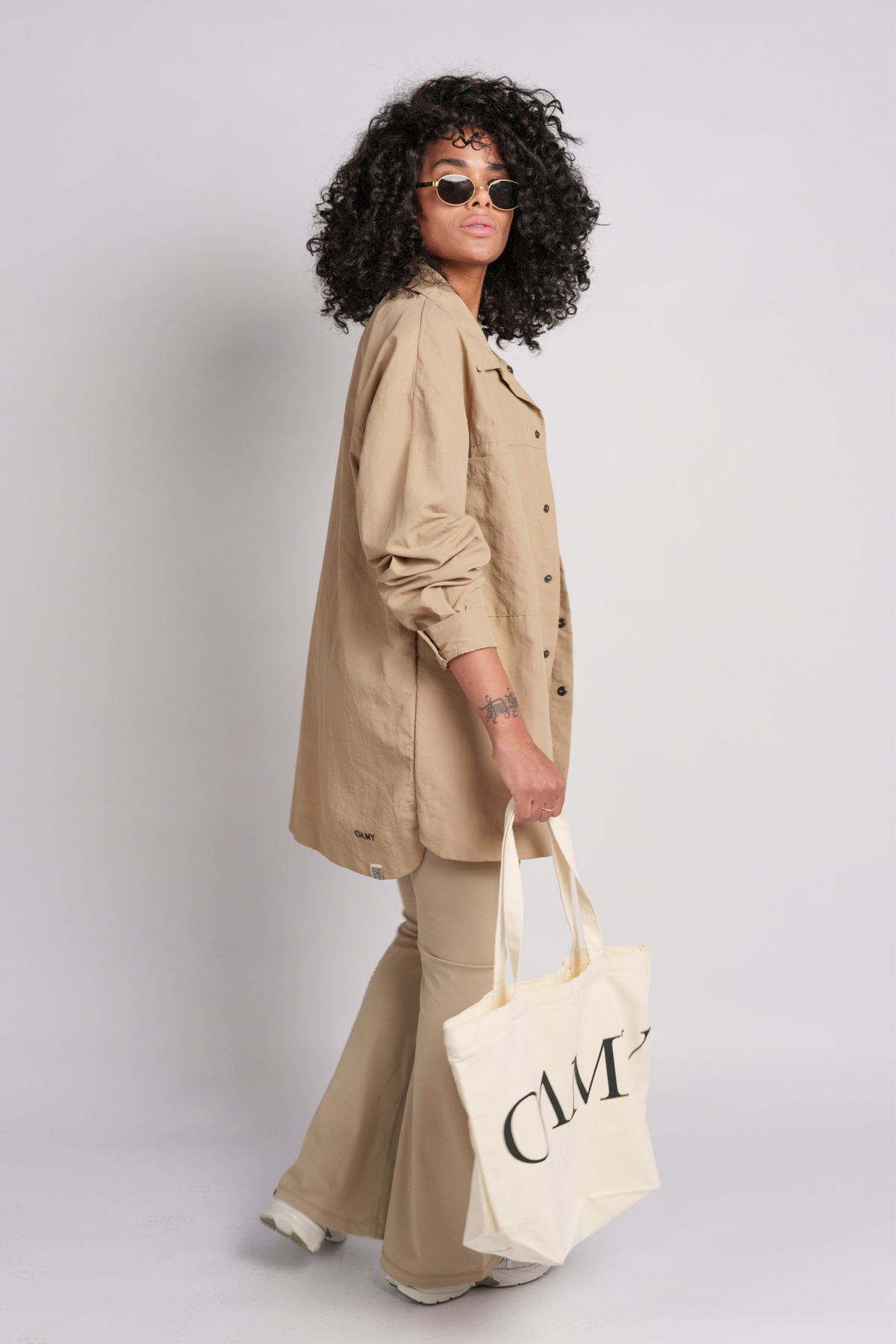 Model wearing a beige shacket and flares